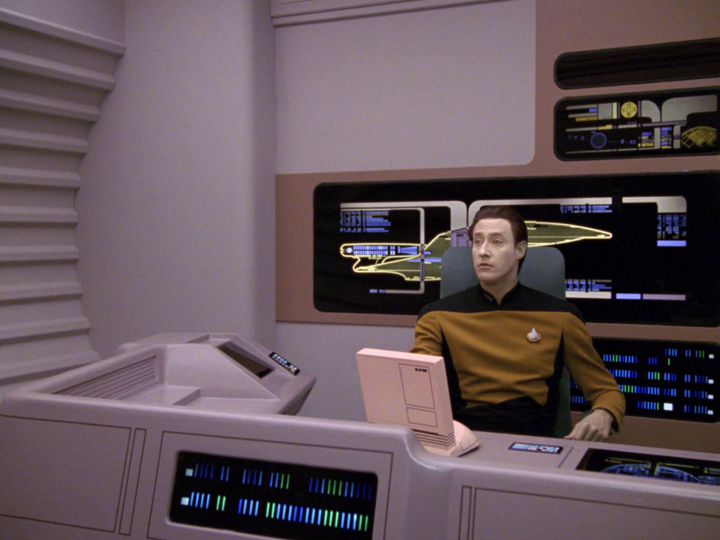 Commander Data sitting at his workstation inside his private quarters